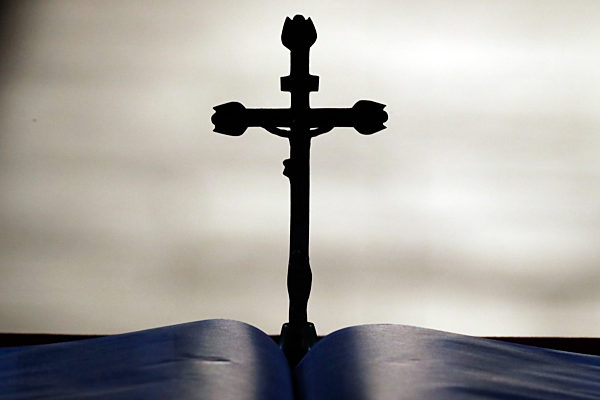 Crucifix and open bible on altar.
