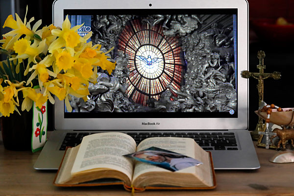 Coronavirus epidemic (COVID-19). Lockdown. Easter 2020. Webcast of the Vatican Resurrection Mass on laptop. 


 France.