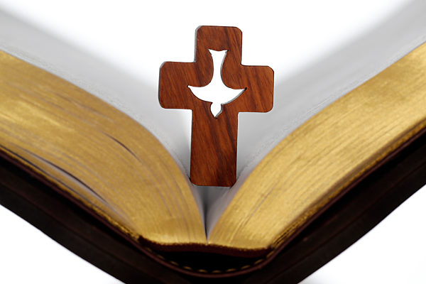 Cross of the order of the Holy Spirit on an open bible. France.