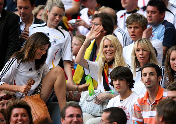 German model Claudia Schiffer (C) waves during the opening group A match of...
