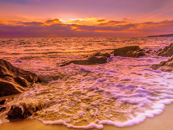 Sunset at a sandy beach with rocks in Tarifa, Spain, Costa de la luz