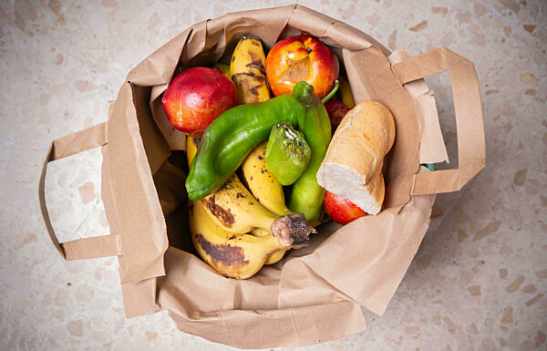 Spoiling Fruit And Bread In A Bin, Symbolic Image Of Food Waste