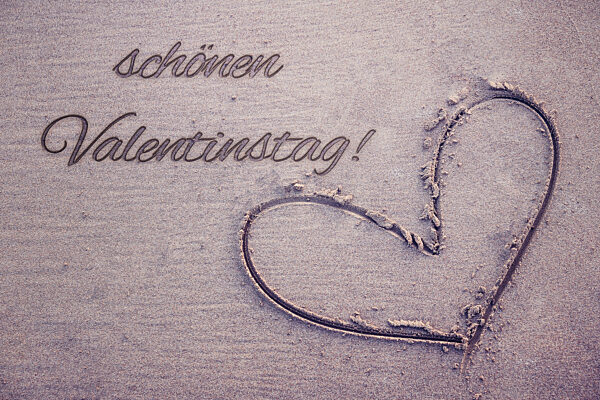 13 February 2023: Heart In Sand With Inscription: Happy Valentine's Day PHOTOMONTAGE
