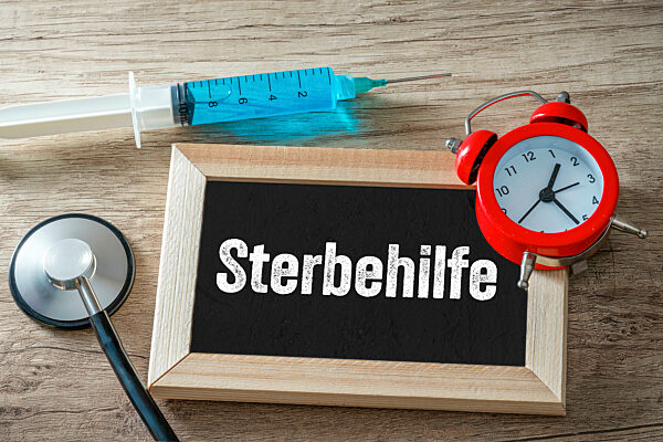 08 July 2023: Euthanasia Symbol Image, A Board With An Alarm Clock And A Syringe With The Inscription: Euthanasia PHOTOMONTAGE