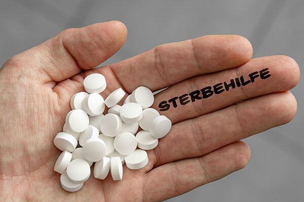 November 22, 2023: Hand Full Of Pills And The Word Euthanasia On The Fingers PHOTOMONTAGE