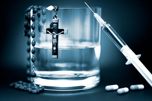 Glass of water, syringe and cross, euthanasia