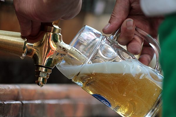 Biergartensaison Zapfen eines Bieres auf dem Viktualienmarkt in Muenchen...