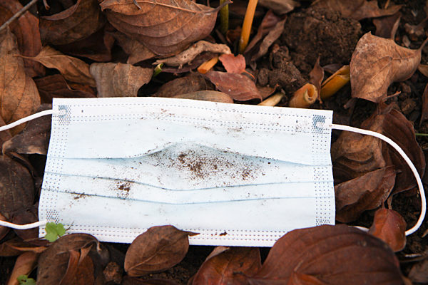 Themenbild - blaue Einwegschutzmaske, Coronamaske, Mundschutz im Freien