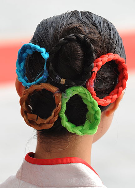 A Chinese girl with the Olympic rings in the hair is pictured during the...
