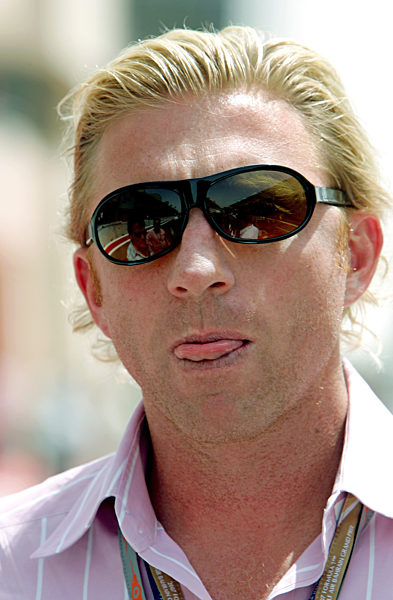 German former tennis champion Boris Becker gestures at the paddock before...
