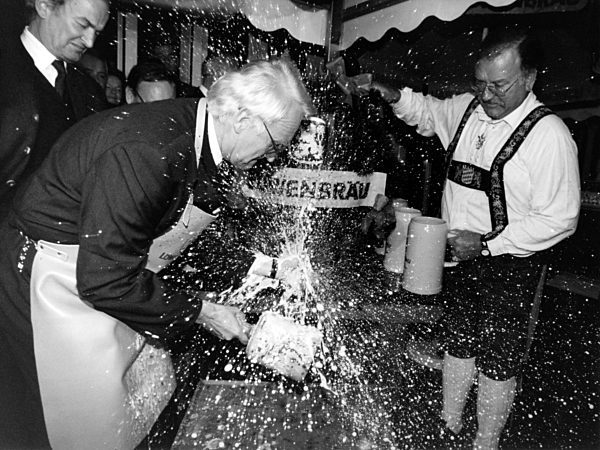 Edmung Stoiber taps a barrel in Bonn