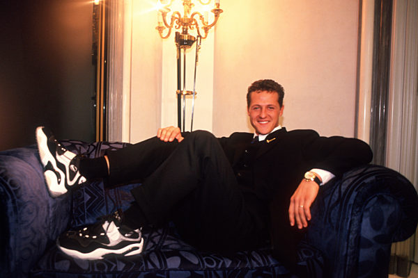 Michael Schumacher Feature liegt im Anzug auf seinem Sofa mit Nike Schuhen...
