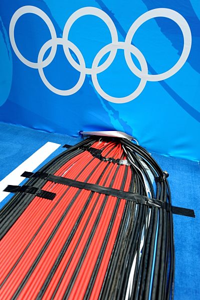 Cables run through a wall below the Olympic rings in the National Indoor...