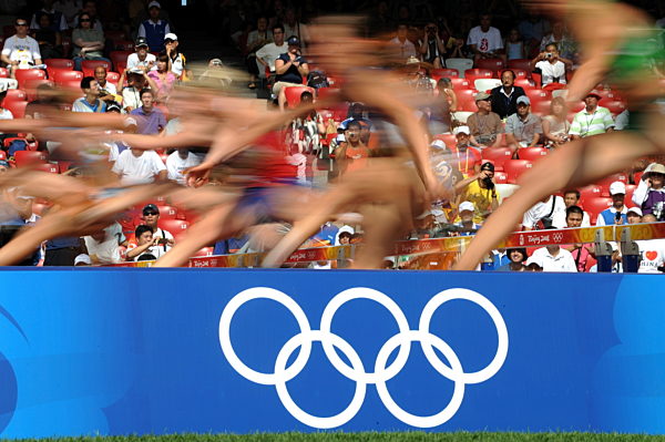 Runners leap hurdles during the 100m hurdles of the women's Heptathlon at...