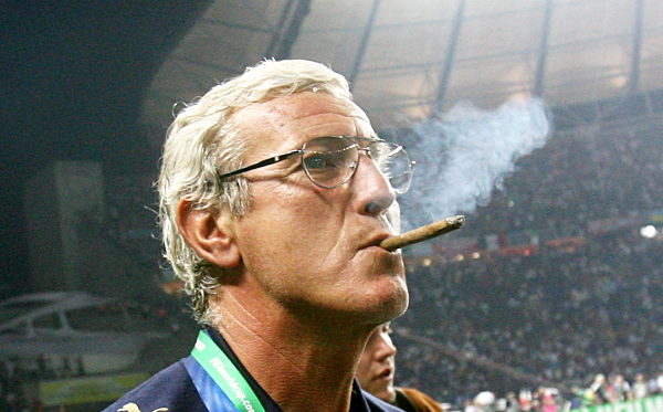 Italian national coach Marcello Lippi celebrates with a small cigar after...