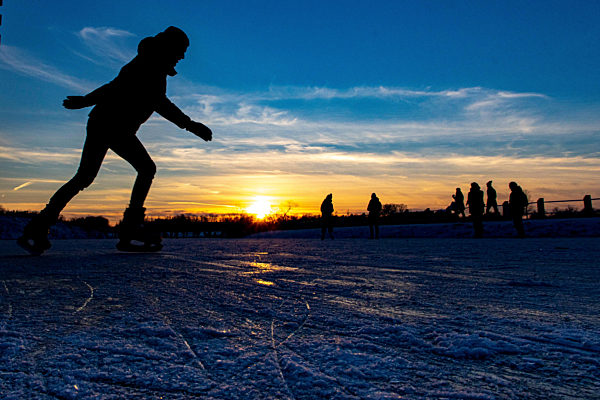 Silhouettes Of Ice Skaters