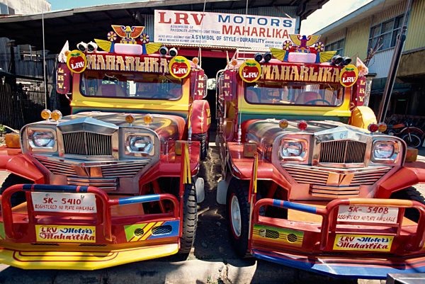 Pair of customised Jeepney trucks, the ubiquitous national transport, Bacolod City, Philippines, Southeast Asia, Asia