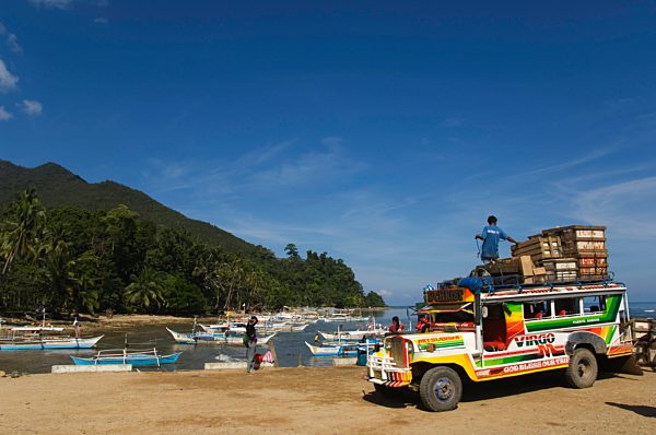 Colouful jeepney loading up at fishing boat harbour, Sabang Town, Palawan, Philippines, Southeast Asia, Asia