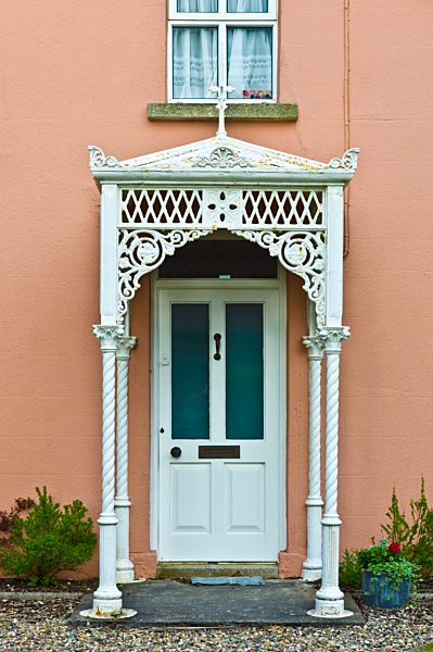 Fretwork ironwork canopy porch on Georgian house on Ocean Drive in Rosslare, Ireland