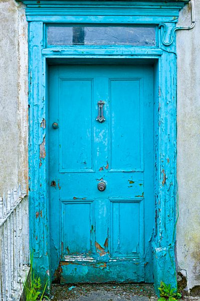 Brightly painted weathered doorway of quayside house in Courtmacsherry, County Cork, Ireland
