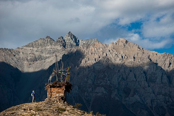 A small chorten strewn with prayer flags marks the top of a hill near Ringmo in Dolpa, a remote region of Nepal