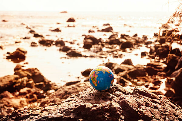 Globe on a rock on the coast