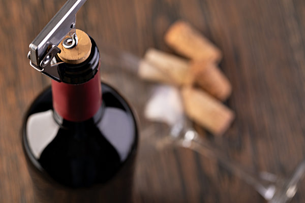 Corkscrew and bottle of wine