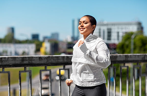 african american woman running outdoors