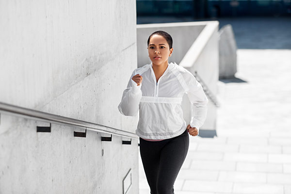 african american woman running upstairs outdoors