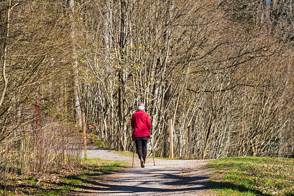 Senior woman walking in the sunshine on a beautiful spring day