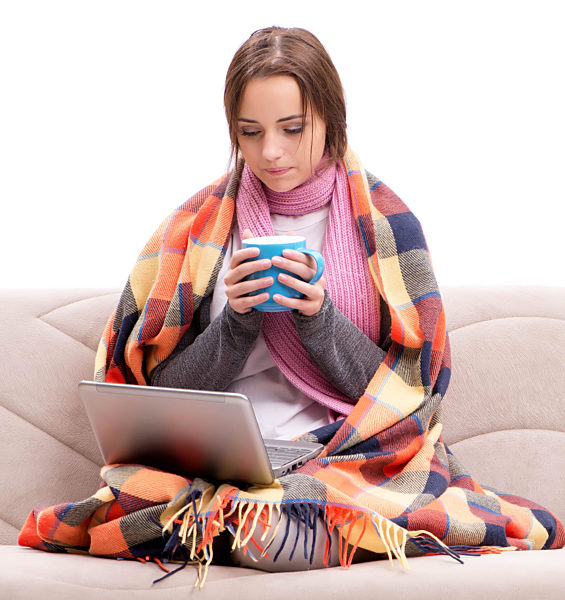 Teenager suffering from cold sitting on coach