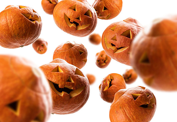 Glowing pumpkins levitate on a white background