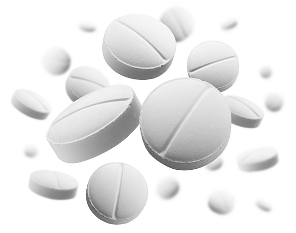 White round tablets levitate on a white background