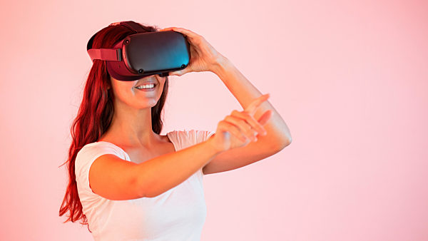 Woman in virtual reality stretching her hand and touching something with finger