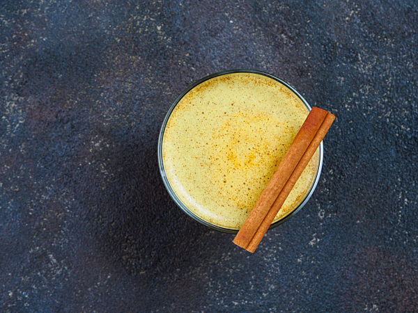 golden turmeric latte and ingredients, copy space