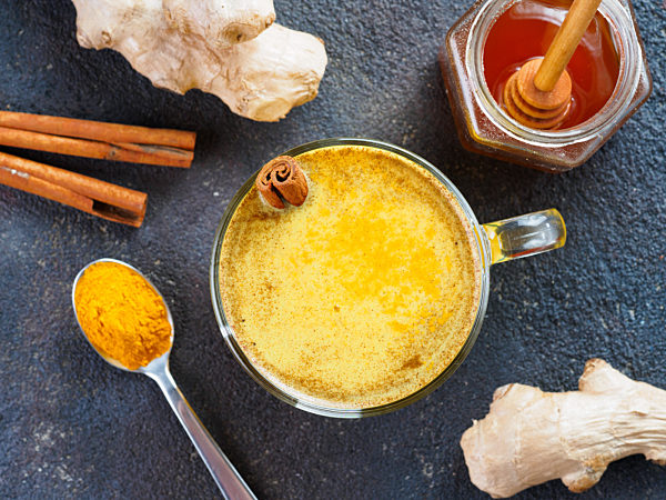 golden turmeric latte and ingredients, copy space