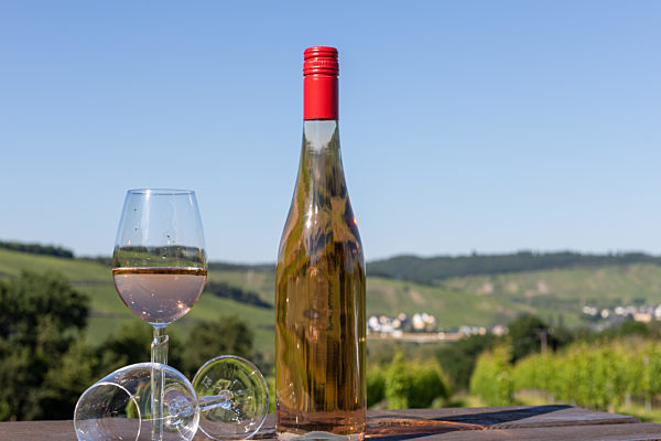 Wine bottle with glasses on wooden table