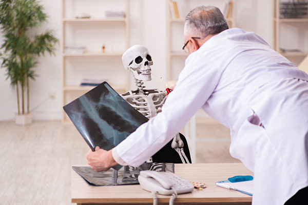 Dead cigarette addicted patient visiting old male doctor