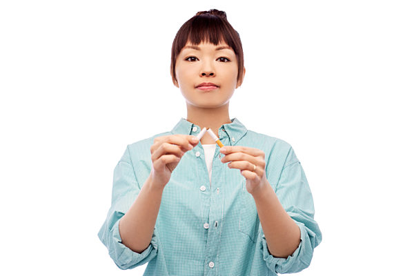 asian woman braking cigarette over white background