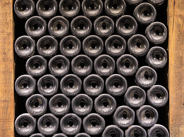 Bottoms of thousands of bottle of wine in old wine-cellar