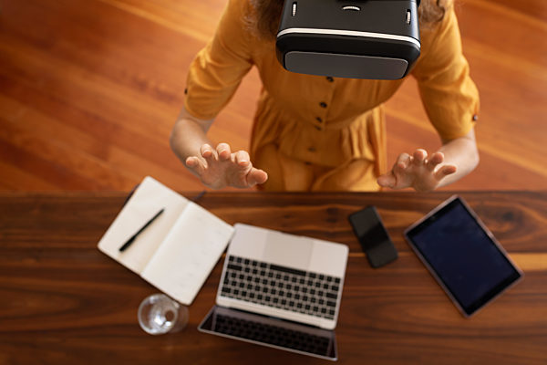Caucasian woman self isolating at home during coronavirus covid19 pandemic using vr headset