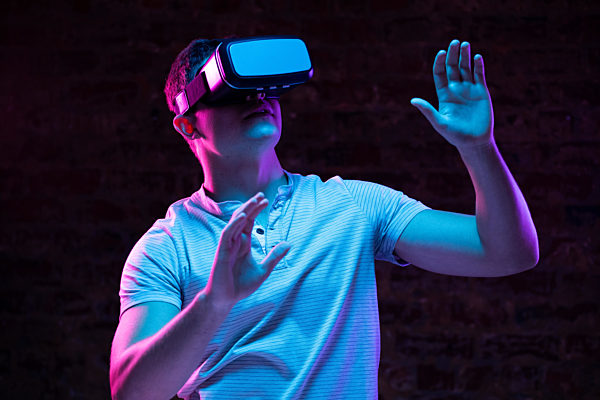 Caucasian man holding a Virtual Reality headset