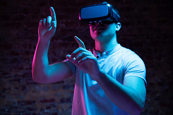 Caucasian man holding a Virtual Reality headset