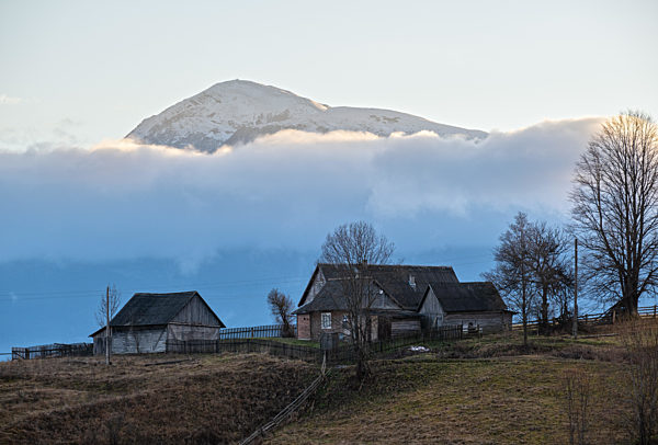 Picturesque morning above late autumn mountain countryside.  Ukraine, Carpathian Mountains, Petros top in far. Peaceful traveling, seasonal, nature and countryside beauty concept scene.