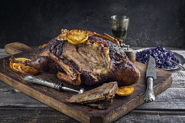 Roast Goose with Orange Slice and Blue Kraut on Cutting Board