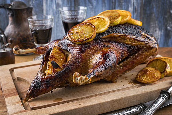 Roast Goose with Orange slices on Cutting Board
