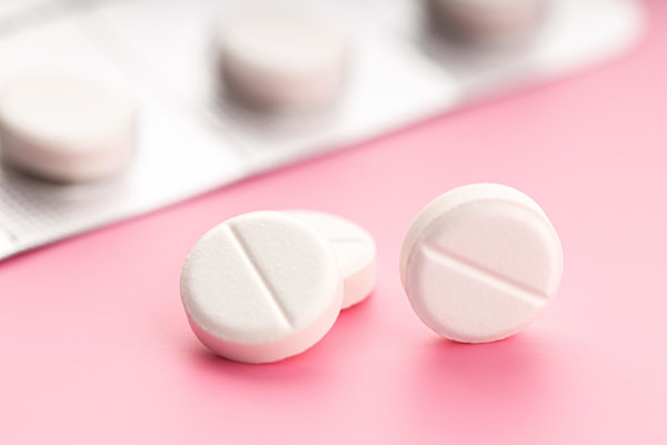 Group of Medicine pills on pink background. Medicine, healthcare and pharmacy concept