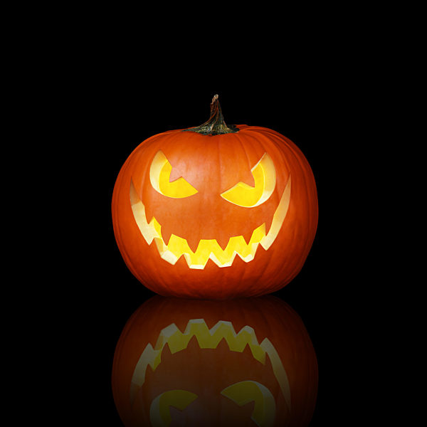 Close up view of scary Halloween pumpkin with eyes glowing inside
