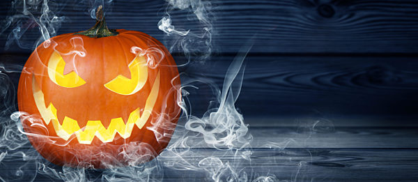 Halloween pumpkin face with burning fire inside.