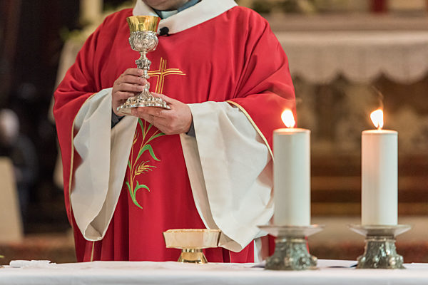 Priest giving Eucharist